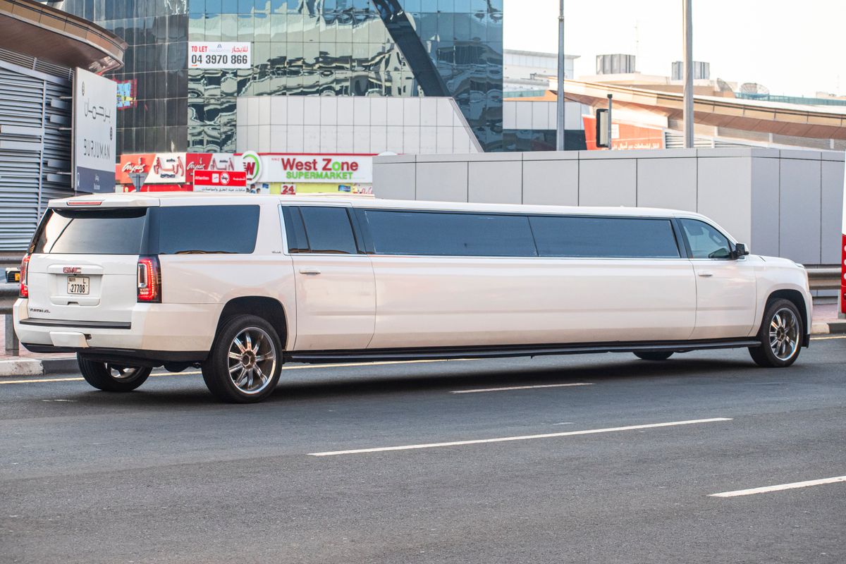 A stretch limousine waiting on a busy city street