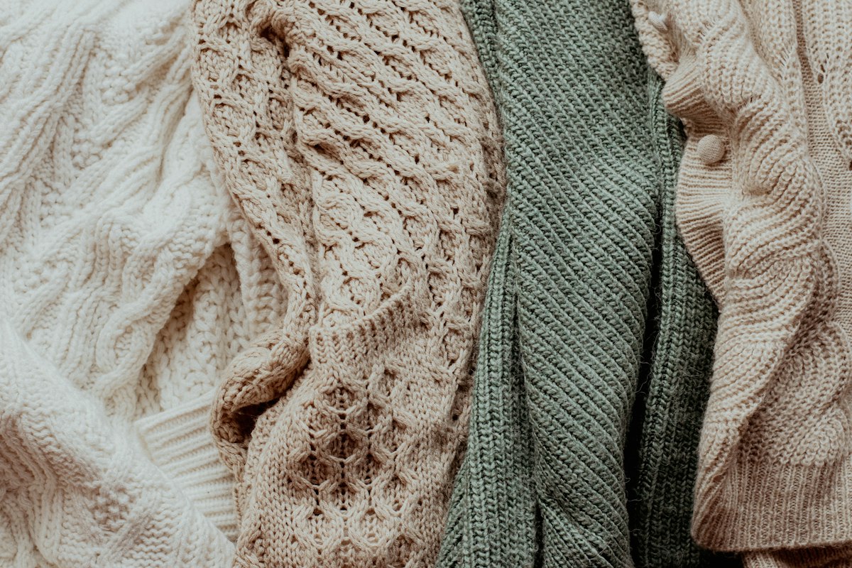 A capsule wardrobe laid out on a bed, autumn pieces ready for a real week